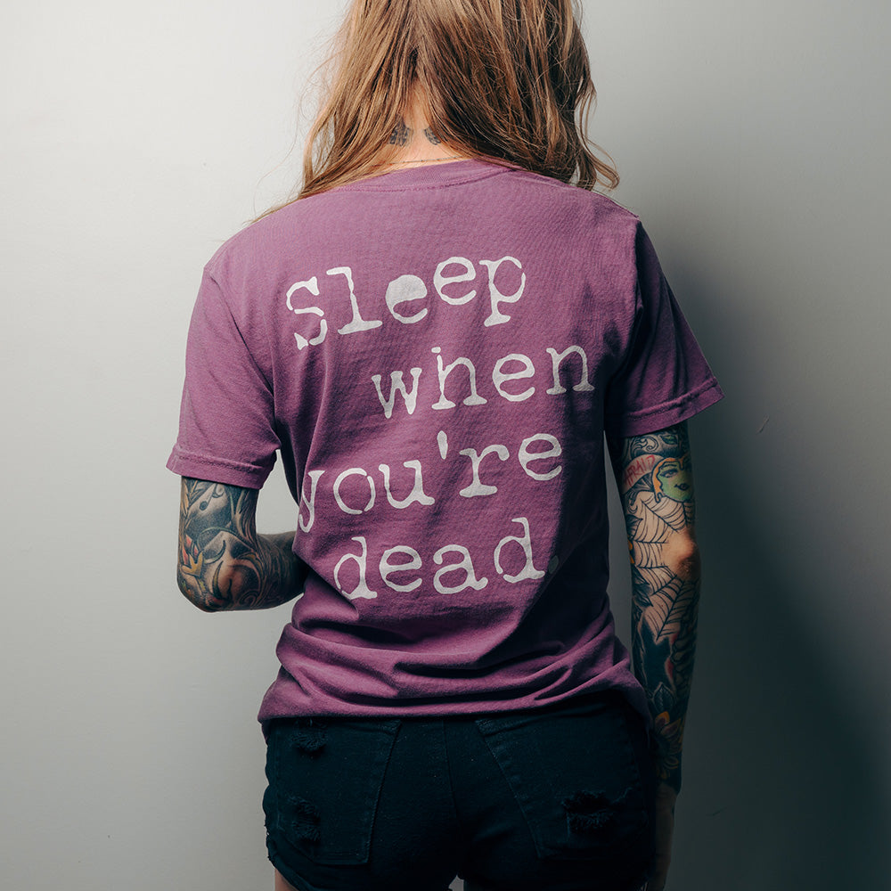 Official 27 Club Coffee Merchandise. Berry purple premium 100% cotton unisex t-shirt with a relaxed fit featuring the 27 Club Coffee logo on the front and the quote "Sleep When You're Dead" on the back.