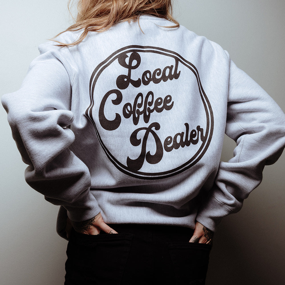 Official 27 Club Coffee Merchandise. 70% cotton / 30% polyester blend, heavy weight heather grey unisex crewneck sweatshirt with the 27 Club Coffee logo printed on the left chest and the Local Coffee Dealer logo printed across the back.