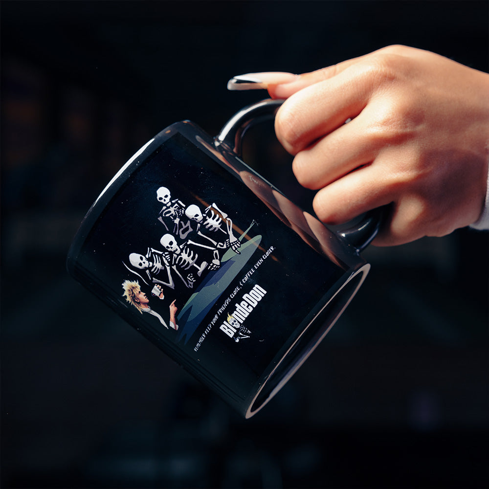 Official 27 Club Coffee Merchandise. Black ceramic mug featuring the Machine Gun Kelly Blonde Don coffee bean bag art printed on both sides.
